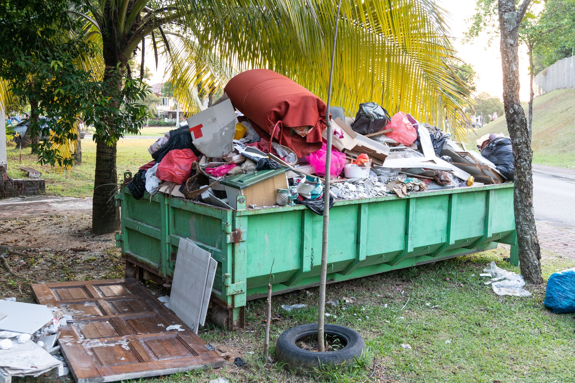 Removal rubbish dumpster bin with load of material for disposal